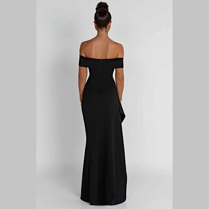 Robe longue noire fendue soirée chic avec épaules dénudées, parfaite pour cocktail ou événement gala.