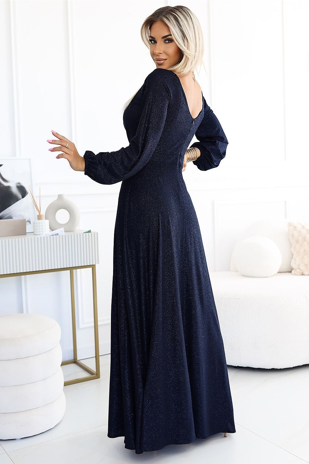 Robe de soirée chic noire longue manches longues dos nu pour un look élégant et sophistiqué.