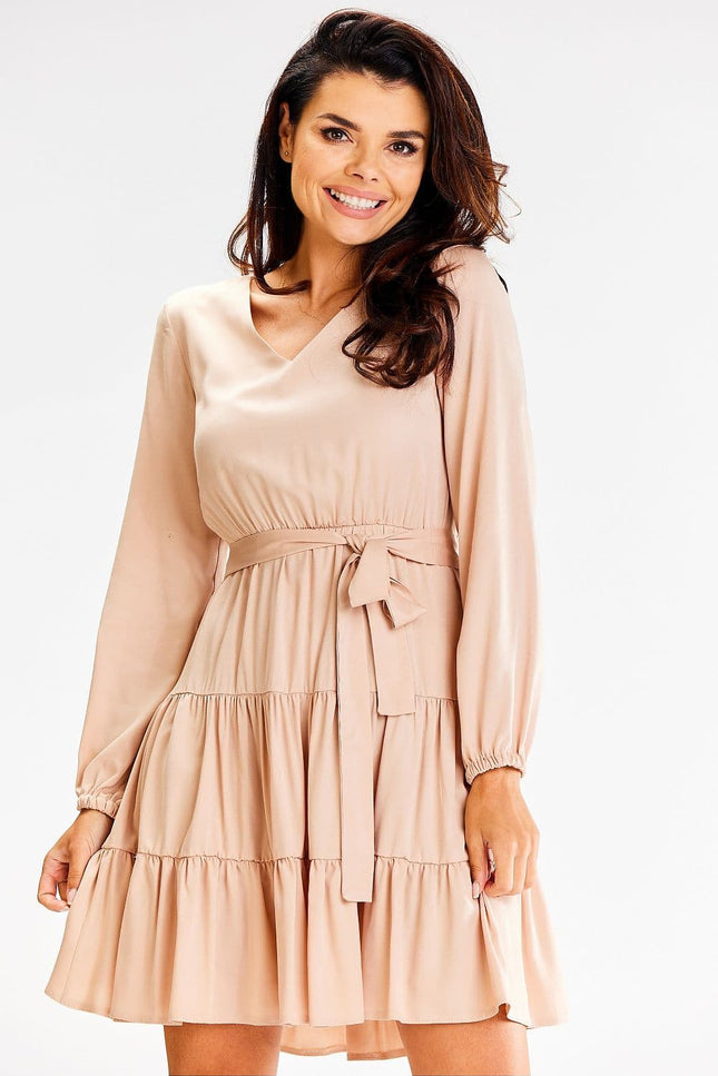 Robe champêtre beige courte à manches longues et ceinture, style décontracté chic idéale pour un mariage ou un événement en plein air.