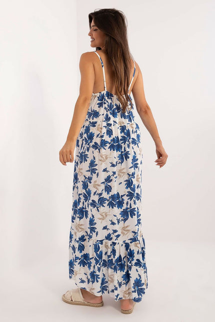 Robe d'été fleurie blanche et bleue, longue avec bretelles fines, idéale pour plage ou journée décontractée.