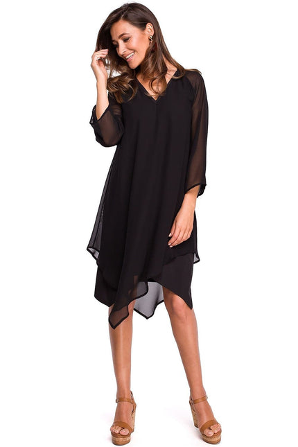 Robe soirée noire midi asymétrique élégante pour cocktail avec manches courtes et encolure dégagée pour une allure chic et moderne.