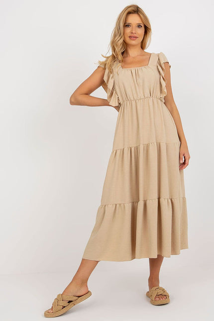 Robe beige midi évasée sans manches pour plage, style décontracté et fluide, idéale pour une sortie estivale ou une journée ensoleillée.