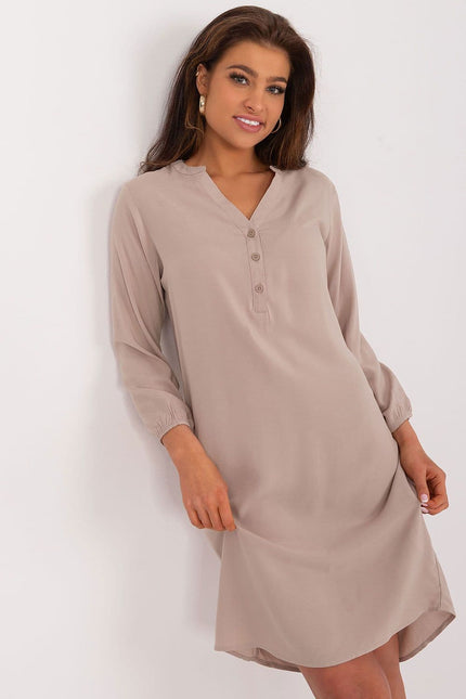 Robe beige fluide à manches longues pour un style casual et élégant, idéale pour toutes les occasions, longueur midi confortable.