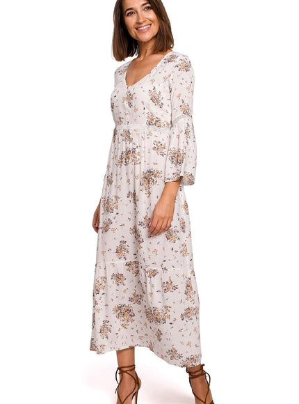 Robe bohème beige à fleurs avec manches longues et longueur midi, idéale pour un style casual ou événements champêtres.