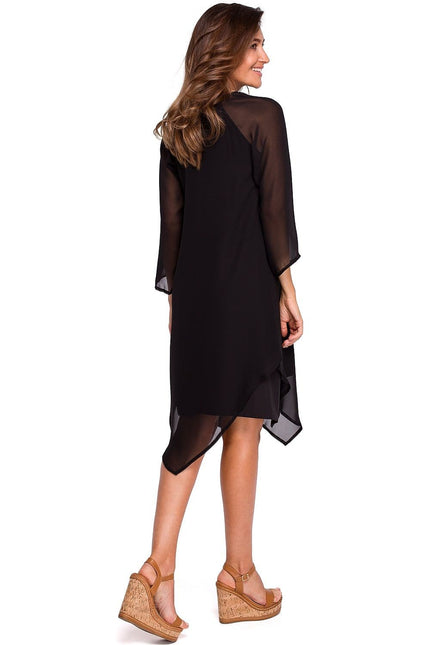 Robe soirée noire asymétrique midi manches longues pour cocktail ou événement chic.