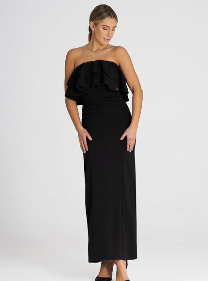 Robe soirée noire longue chic avec épaules dénudées, idéale pour cocktail ou gala, silhouette moulante et féminine.