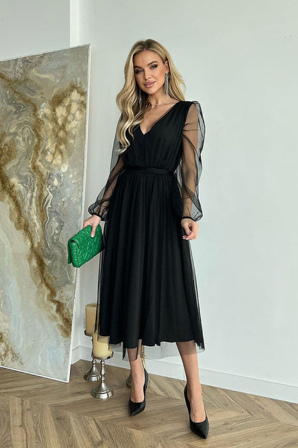 Robe soirée chic noire midi à manches longues transparentes, idéale pour cocktail ou gala, silhouette élégante.