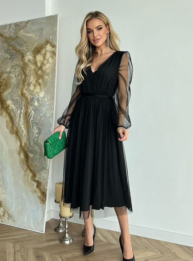 Robe soirée chic noire midi à manches longues transparentes, idéale pour cocktail ou gala, silhouette élégante.