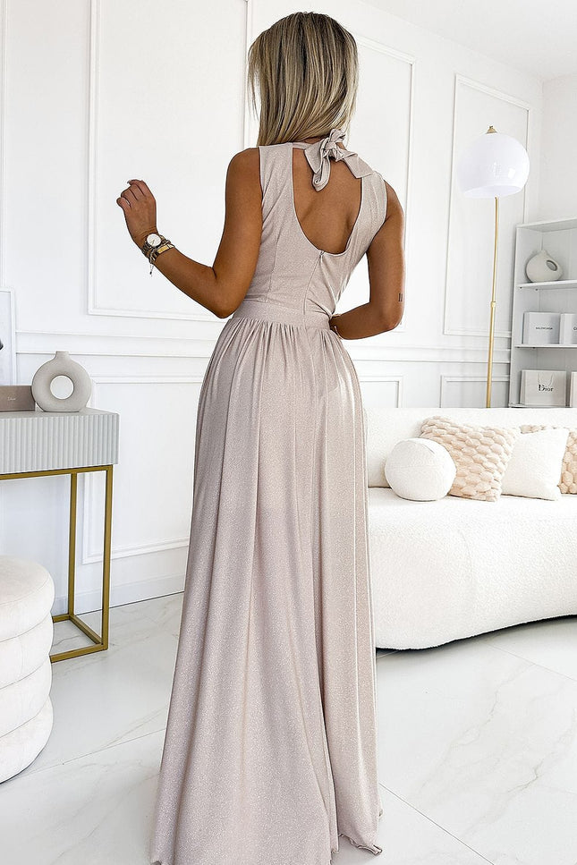 Robe soirée chic sequin longue beige, sans manches avec noeud élégant au dos, idéale pour cocktail ou événement.