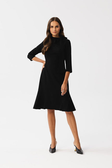 Robe noire chic midi à manches longues pour soirée, cocktail ou événement formel, coupe évasée élégante.