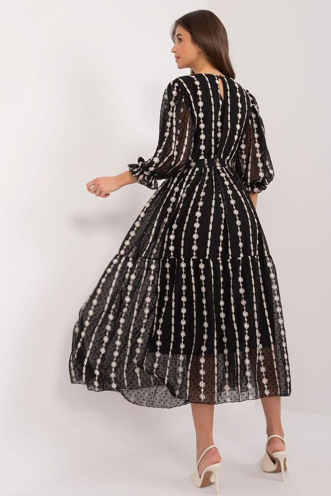 Robe noire à paillettes style soirée chic, longueur midi avec manches courtes, idéale pour cocktail ou évènement élégant.