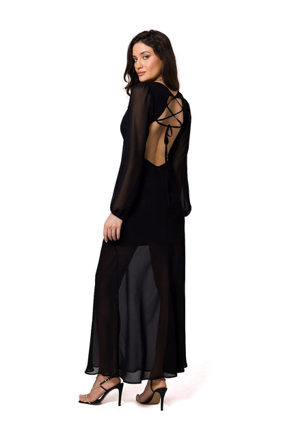 Robe soirée noire longue élégante avec dos nu et manches longues, idéale pour gala ou événement chic.