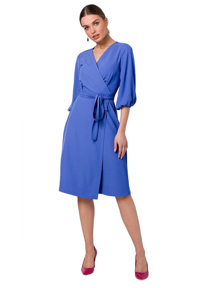 Robe portefeuille bleue midi chic avec manches longues, idéale pour cocktail ou événement d'entreprise, silhouette élégante et moderne.