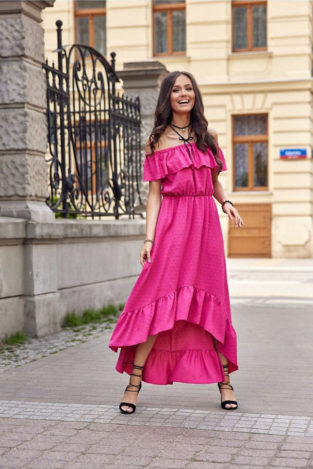 Robe rose bohème longue pour été, style épaules dénudées et volants, parfaite pour soirée décontractée ou évènement en plein air.