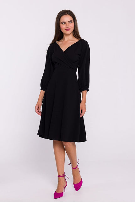 Robe noire soirée chic manche longue midi pour femme, idéale pour cocktail ou gala.